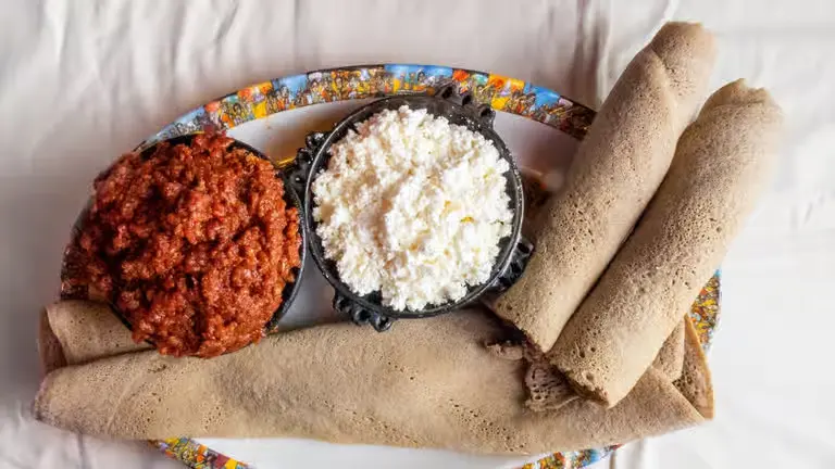 Dulet Kitfo spiced minced Ethiopian beef tripe and liver sauteed with onion pepper and kibbeh at Merkato Restaurant Winnipeg