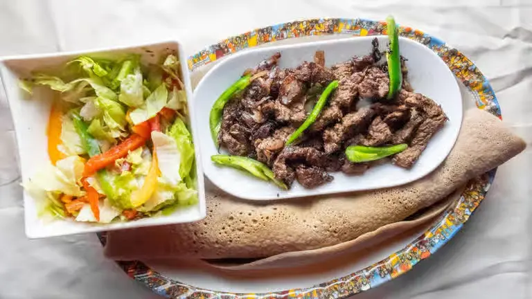 Zelzel Tibs tender strips of Ethiopian beef sauteed with onion tomato green pepper and spices at Merkato Restaurant Winnipeg